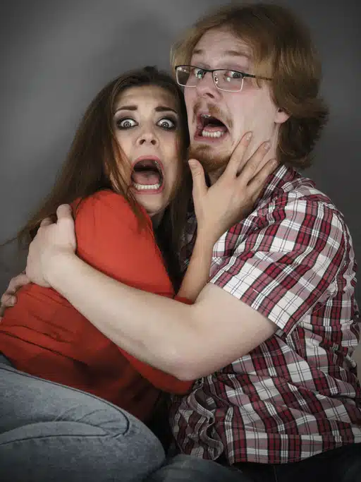 couple with funny horror look on faces
